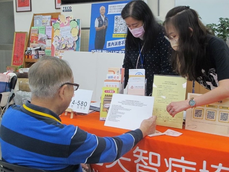 a wicker chair with a pillow and a plant